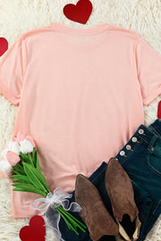 a t - shirt, jeans, flowers, and a pair of shoes on a