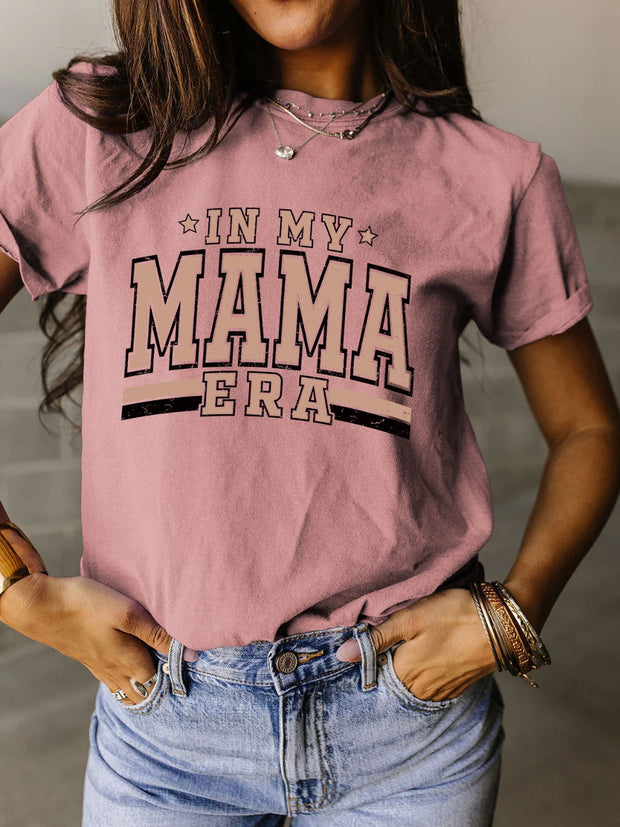 a woman wearing a pink shirt that says i'm my mama