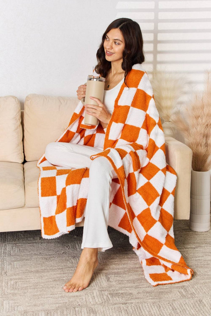 a woman sitting on a couch holding a cup of coffee