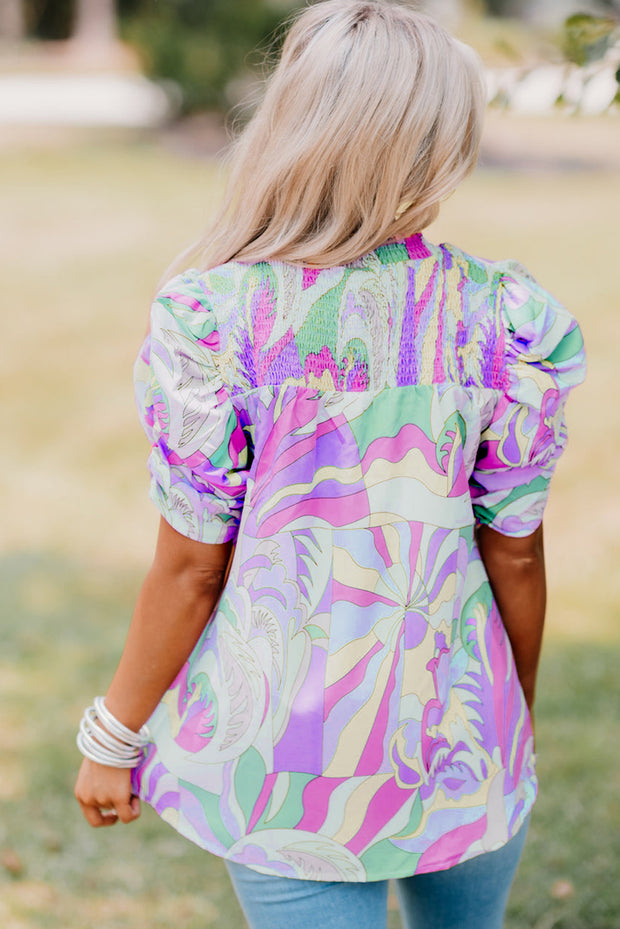 the back of a woman wearing a colorful top
