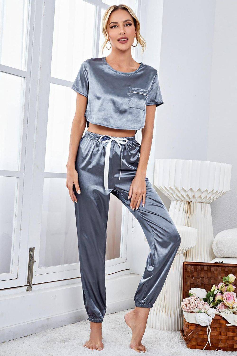 a woman wearing a silver top and matching pants
