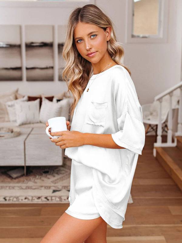 a woman standing in a living room holding a cup of coffee
