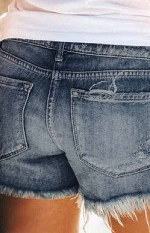 a woman's butt showing the back of her jean shorts