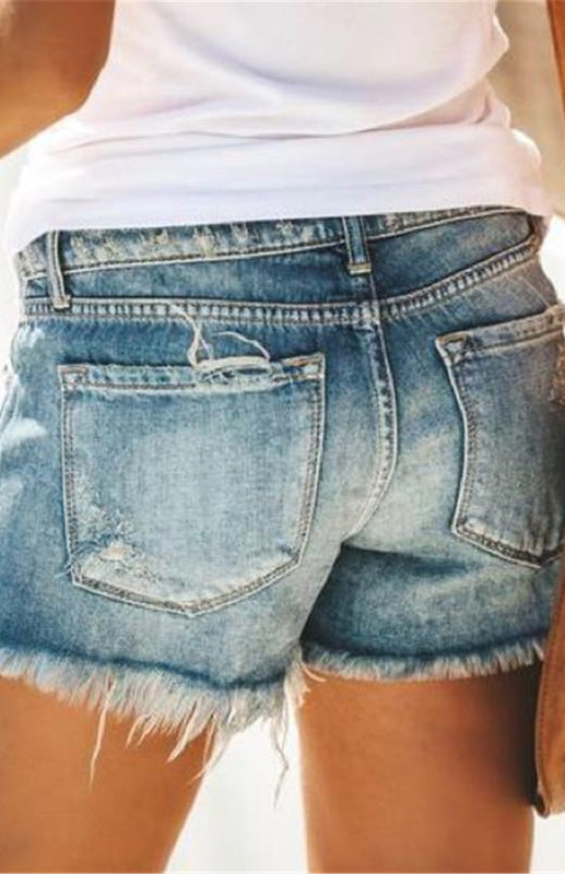 a woman wearing a pair of jean shorts