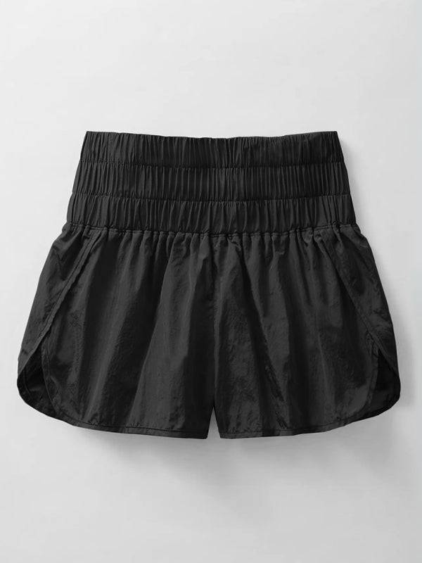 a pair of black shorts hanging on a wall