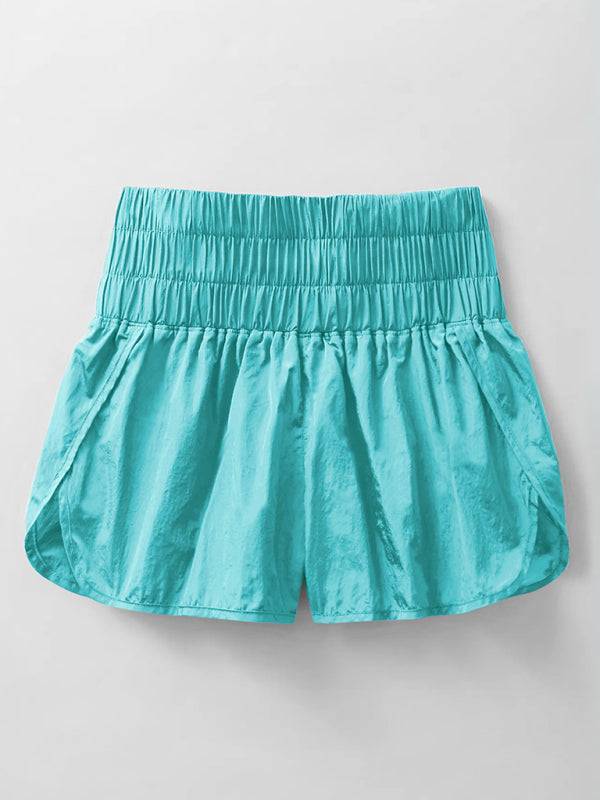 a pair of turquoise shorts hanging on a wall