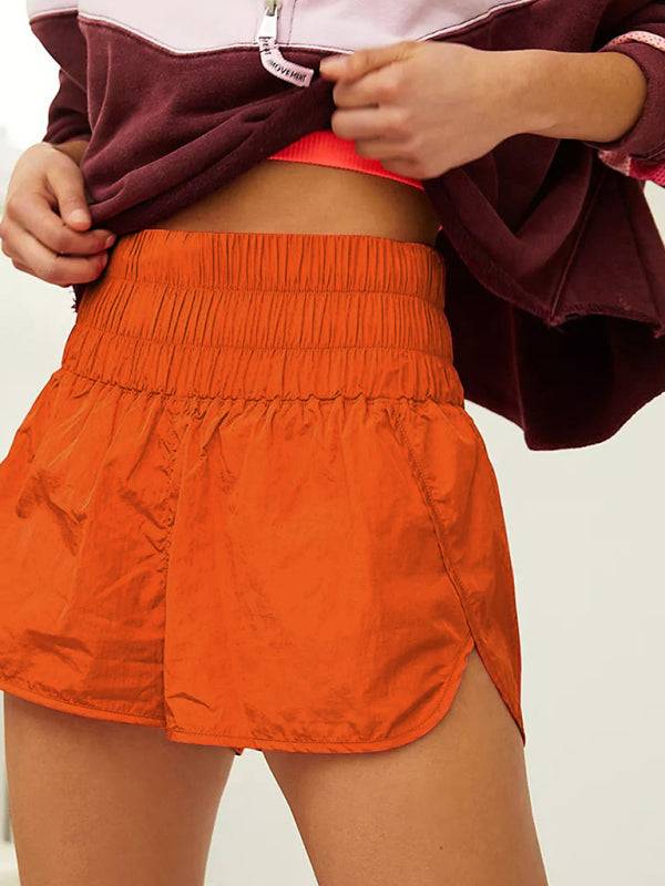a close up of a person wearing an orange skirt
