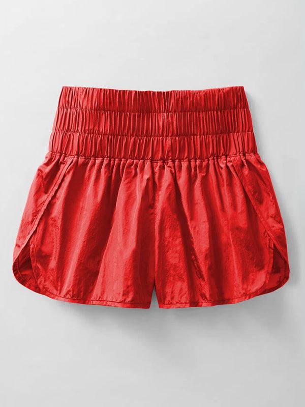 a pair of red shorts hanging on a wall
