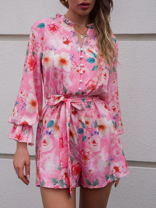 a woman is wearing a pink floral romper