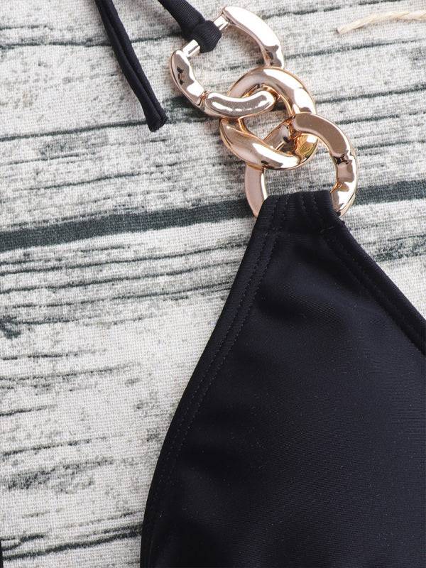 a black purse with a gold chain hanging from it