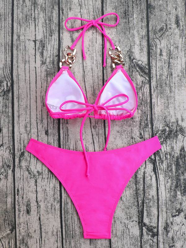 a pink bikini with a bow tie on a wooden surface