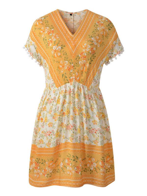 a yellow and white dress with flowers on it