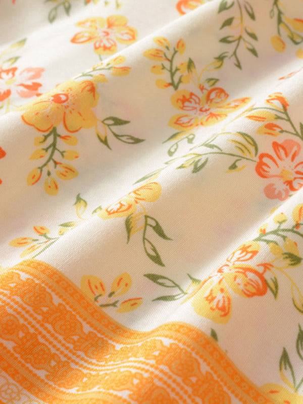 a close up of a white and orange flowered fabric