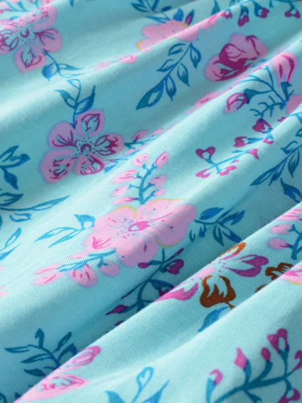 a close up of a blue and pink flowered dress