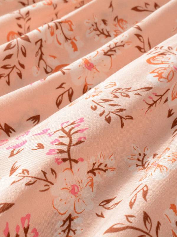 a close up of a pink and brown floral print fabric