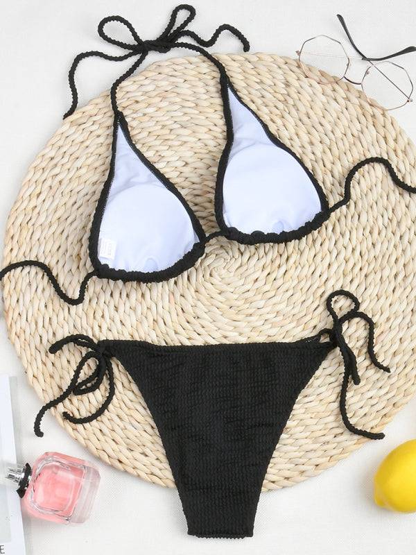 a black and white bikini top and a straw hat