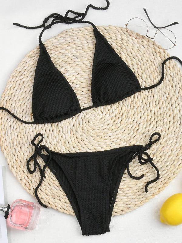 a black bikini top and a straw hat