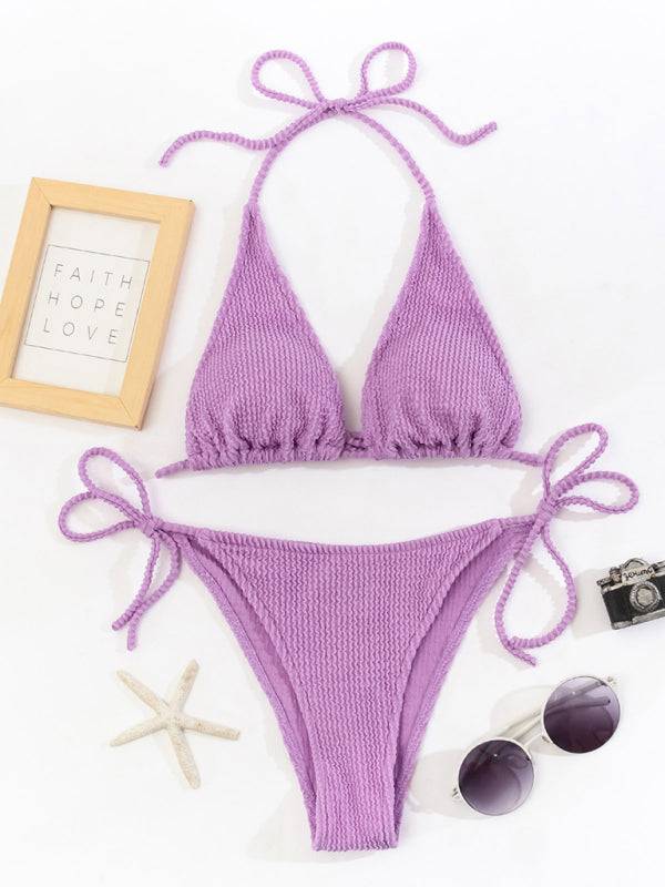 a woman's purple bikini top and sunglasses