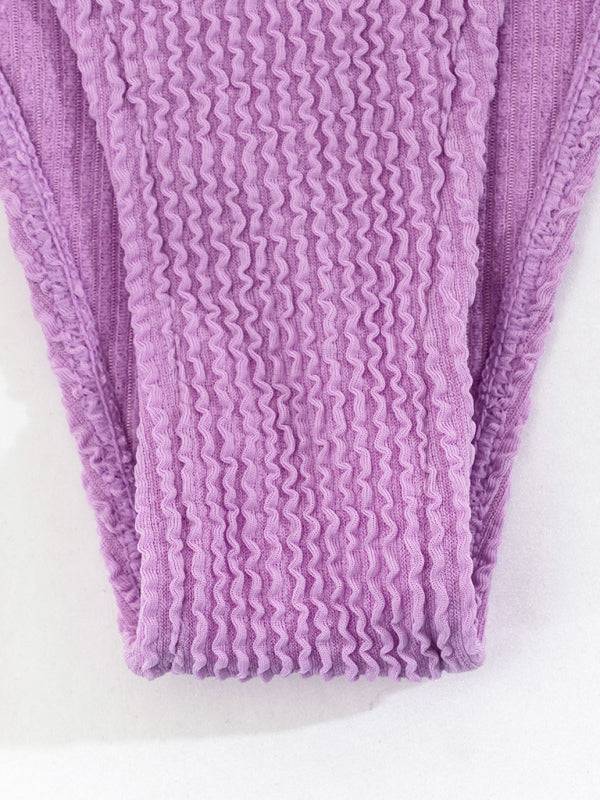 a close up of a purple towel on a white surface