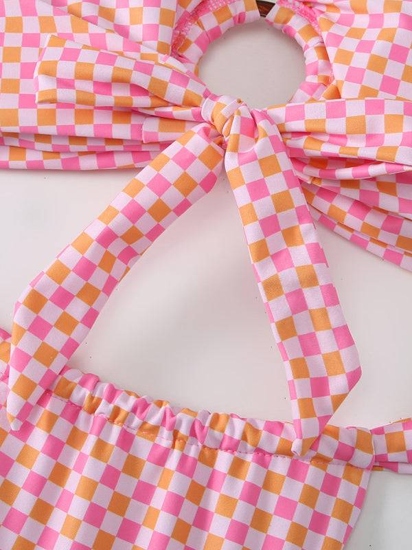 a close up of a pink and orange checkered tie