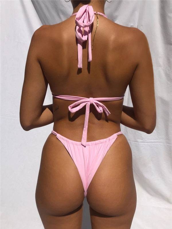a woman in a pink bikini with a tie around her neck