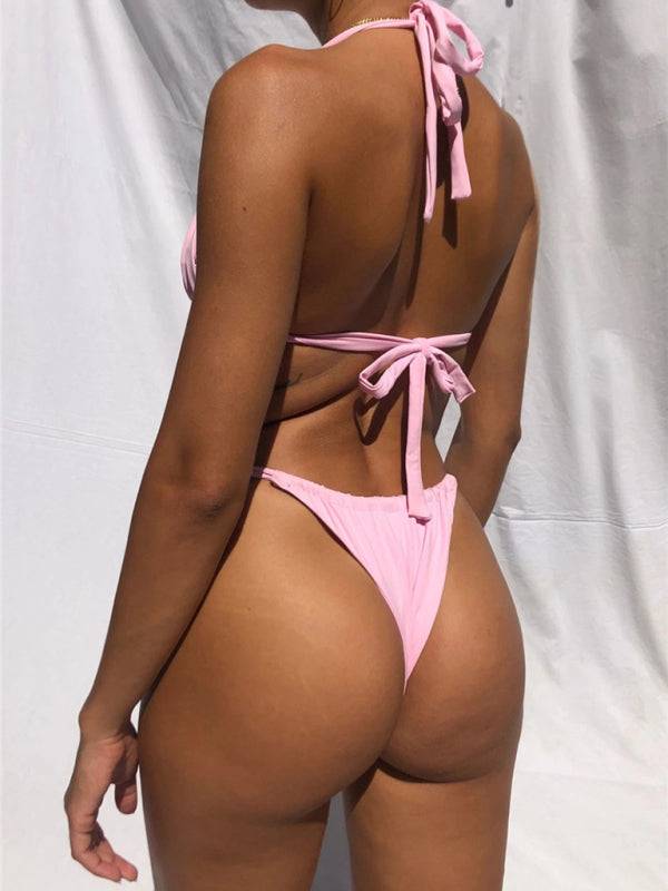 a woman in a pink bikini with her back to the camera