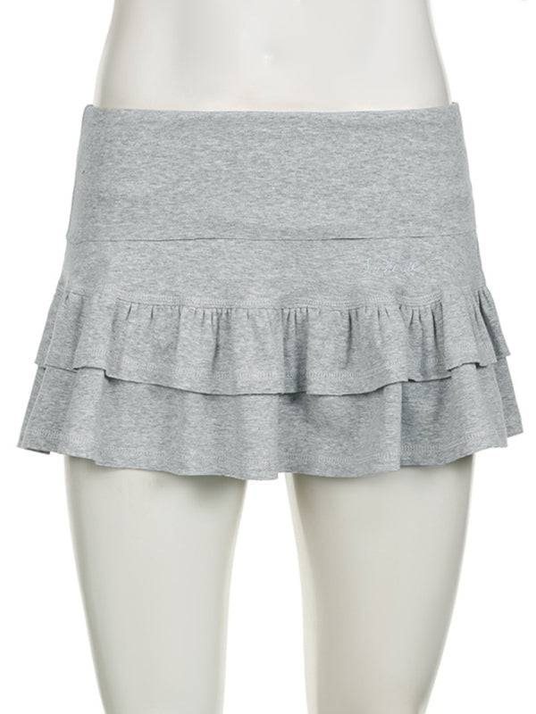 a female mannequin wearing a gray skirt