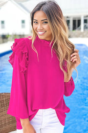 a woman standing next to a pool wearing a pink top