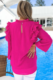 a woman standing next to a pool wearing a pink top