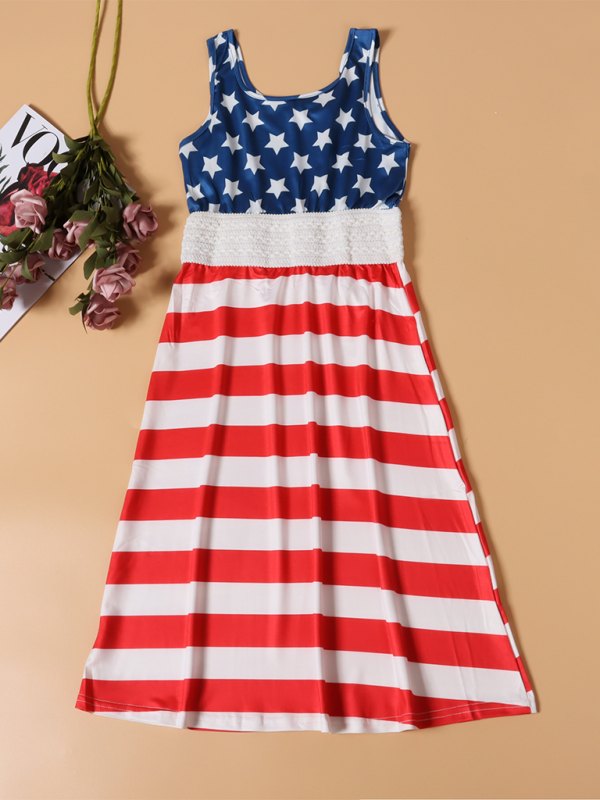 a red, white and blue dress next to a plant