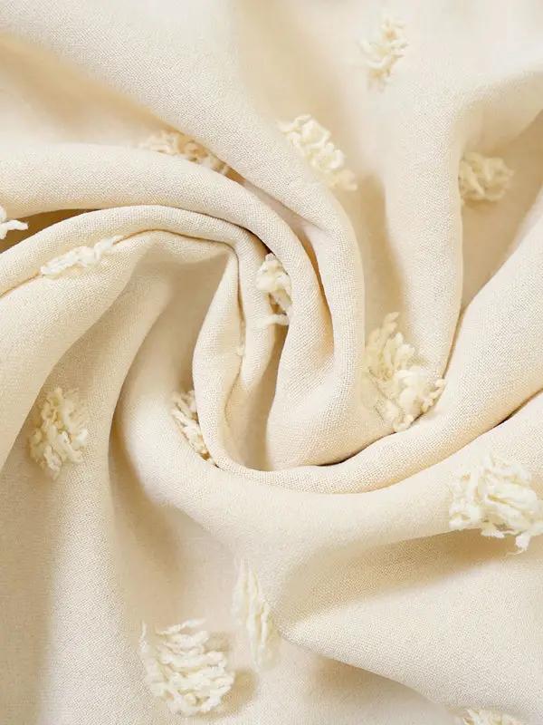 a white fabric with white flowers on it