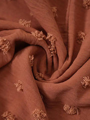 a close up of a brown fabric with flowers on it
