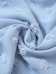a blue fabric with white flowers on it