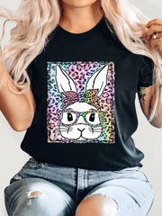 a woman wearing a black t - shirt with an image of a rabbit on it