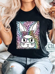a woman wearing a black t - shirt with an image of a rabbit on it