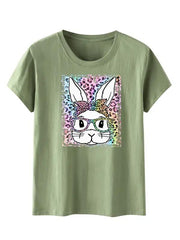 a green t - shirt with an image of a rabbit wearing glasses