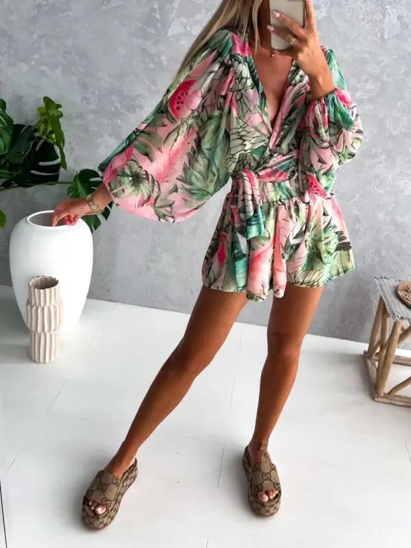 a woman taking a selfie in a tropical print dress