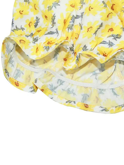 a yellow and white hat with flowers on it