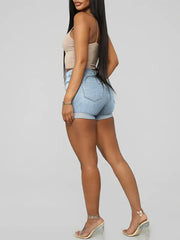 a woman in high rise denim shorts and heels