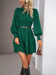 a woman in a green dress and black boots