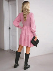 a woman wearing a pink dress and black boots