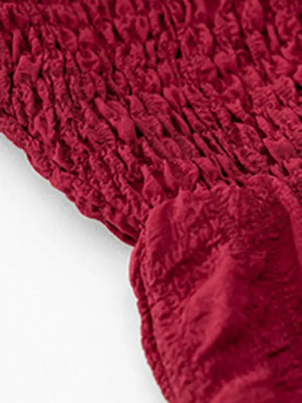a close up of a red towel on a white surface