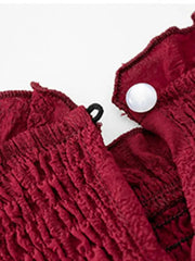 a close up of a red jacket with buttons on it