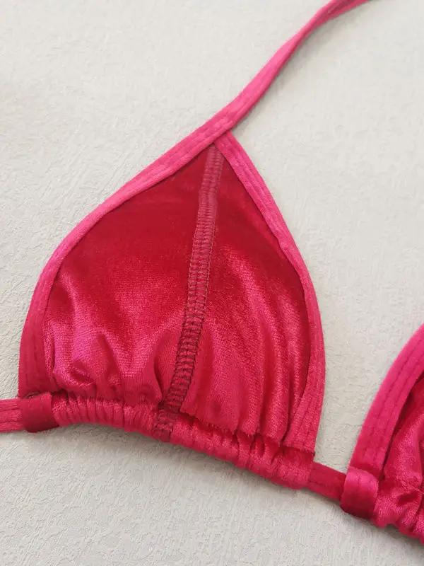 a close up of a bikini top on a bed