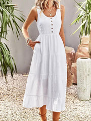 a woman wearing a white dress with buttons