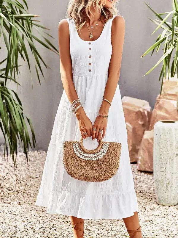 a woman in a white dress holding a straw bag