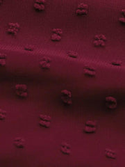 a close up of a red fabric with small dots