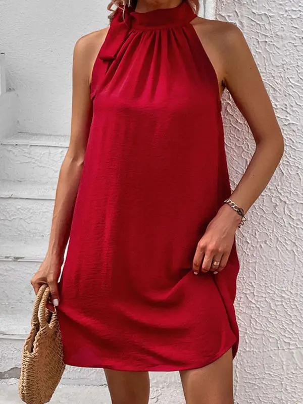 a woman wearing a red dress and a straw bag
